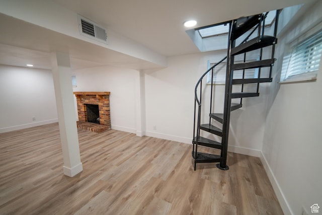 627 W La Salle Dr, Murray, UT 84123 - basement featuring visible vents, baseboards, a fireplace, wood finished floors, and stairway