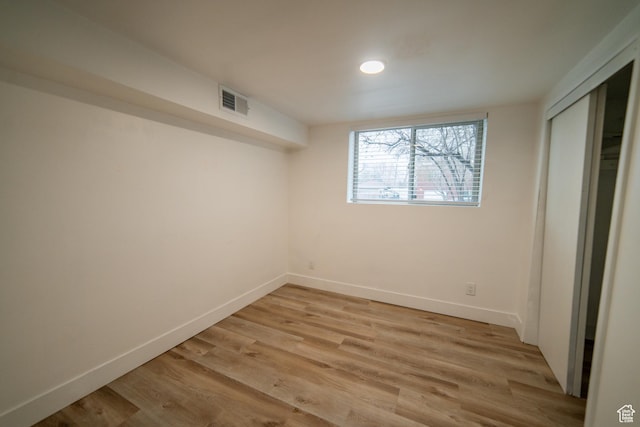 627 W La Salle Dr, Murray, UT 84123 - unfurnished bedroom featuring a closet, baseboards, light wood finished floors, and visible vents