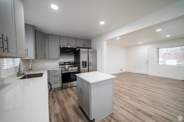 627 W La Salle Dr, Murray, UT 84123 - kitchen featuring light countertops, light wood-style flooring, stainless steel appliances, a sink, and gray cabinets