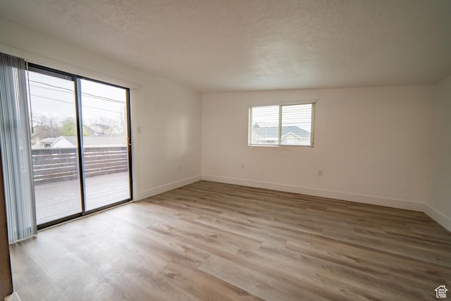 627 W La Salle Dr, Murray, UT 84123 - empty room with baseboards, a textured ceiling, and light wood finished floors