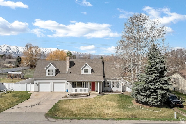 385 N 300 E, Providence, UT 84332 - new england style home featuring fence, a chimney, a front lawn, driveway, and covered porch