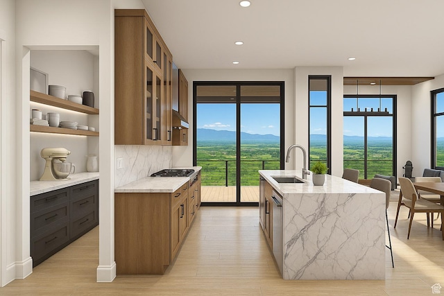 912 W Summit Creek Dr, Woodland Hills, UT 84653 - kitchen featuring a sink, light stone counters, recessed lighting, brown cabinetry, and a mountain view