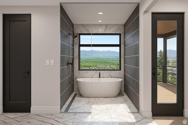 912 W Summit Creek Dr, Woodland Hills, UT 84653 - bathroom featuring a freestanding tub, tile walls, marble finish floors, a mountain view, and recessed lighting