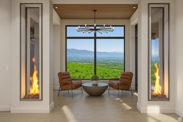 912 W Summit Creek Dr, Woodland Hills, UT 84653 - living area with baseboards, a chandelier, wooden ceiling, a mountain view, and wood finished floors