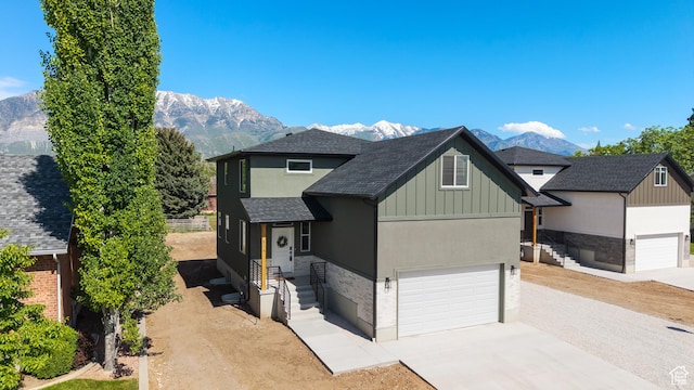 514 N 450 W, Orem, UT 84057 - view of front of house featuring a mountain view, driveway, a shingled roof, and board and batten siding