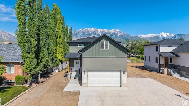 514 N 450 W, Orem, UT 84057 - view of front of home with driveway, a mountain view, board and batten siding, a garage, and stucco siding