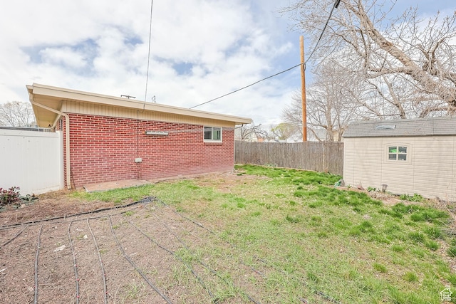 2645 S Masonic Cir E, South Salt Lake, UT 84115 - view of yard with a fenced backyard and an outbuilding