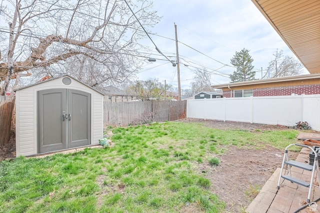2645 S Masonic Cir E, South Salt Lake, UT 84115 - view of yard featuring a fenced backyard, an outdoor structure, and a storage shed
