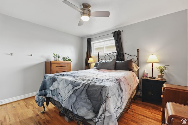 2645 S Masonic Cir E, South Salt Lake, UT 84115 - bedroom with baseboards, wood finished floors, and a ceiling fan