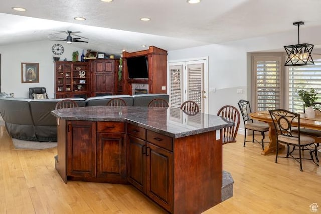 3011 N 1000 W, Pleasant View, UT 84414 - kitchen featuring ceiling fan, decorative light fixtures, light wood-style floors, open floor plan, and vaulted ceiling