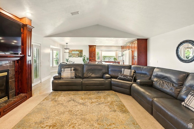 3011 N 1000 W, Pleasant View, UT 84414 - living area with vaulted ceiling, light carpet, and a tiled fireplace