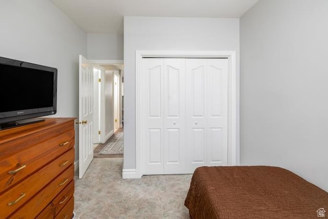 3011 N 1000 W, Pleasant View, UT 84414 - bedroom with light colored carpet, a closet, and baseboards
