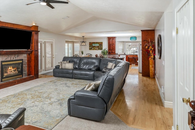 3011 N 1000 W, Pleasant View, UT 84414 - living room featuring ceiling fan, vaulted ceiling, a tiled fireplace, and light wood-type flooring