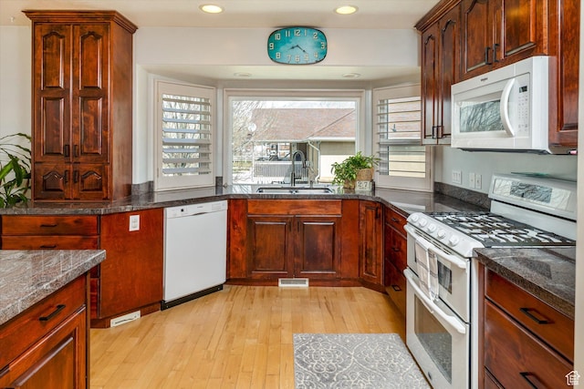 3011 N 1000 W, Pleasant View, UT 84414 - kitchen with white appliances, light wood-type flooring, dark stone counters, and recessed lighting