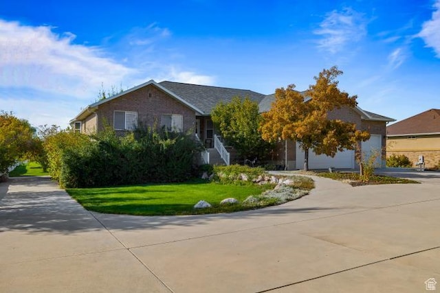3011 N 1000 W, Pleasant View, UT 84414 - view of front facade featuring brick siding, driveway, a garage, and a front lawn
