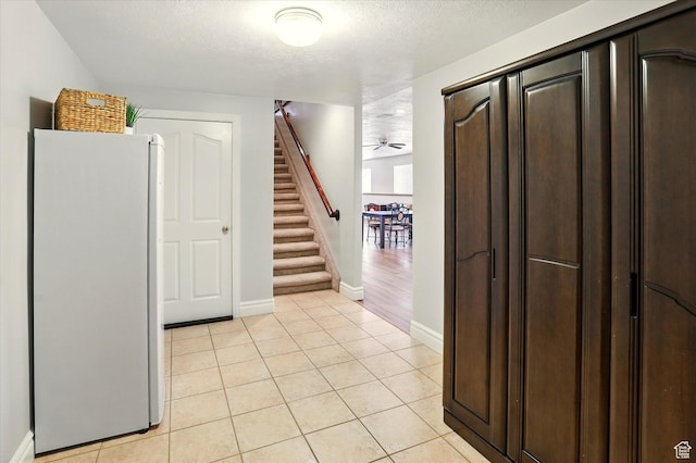 3011 N 1000 W, Pleasant View, UT 84414 - interior space featuring stairs, light tile patterned floors, and a textured ceiling