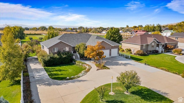 view of front of house featuring a residential view, driveway, a front yard, and an attached garage