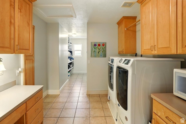 3011 N 1000 W, Pleasant View, UT 84414 - laundry room featuring attic access, washing machine and dryer, light tile patterned flooring, cabinet space, and a textured ceiling