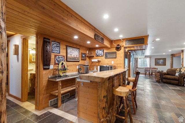 376 W Golden Harvest Rd, Draper, UT 84020 - bar with baseboards, wood walls, recessed lighting, and stone tile floors