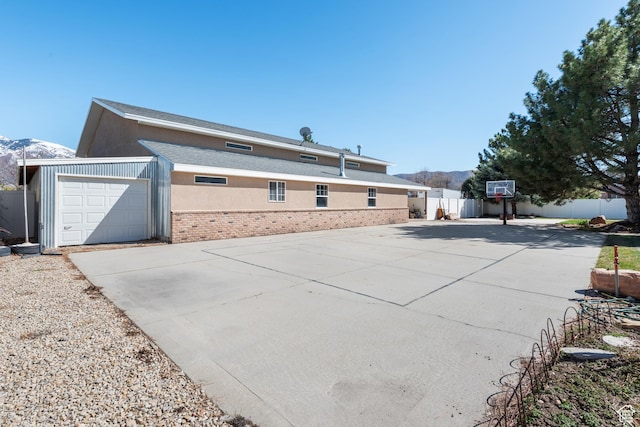376 W Golden Harvest Rd, Draper, UT 84020 - exterior space featuring concrete driveway, stucco siding, fence, a mountain view, and a garage