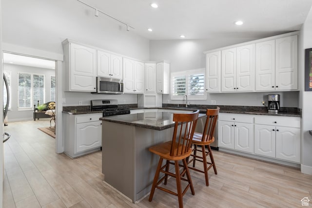 376 W Golden Harvest Rd, Draper, UT 84020 - kitchen featuring white cabinets, a sink, light wood finished floors, and appliances with stainless steel finishes