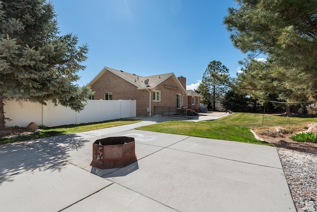 376 W Golden Harvest Rd, Draper, UT 84020 - back of house featuring fence, a lawn, a patio, brick siding, and a chimney