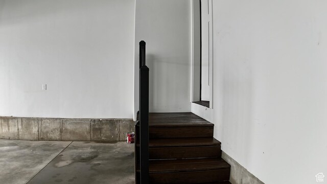 stairs featuring concrete floors