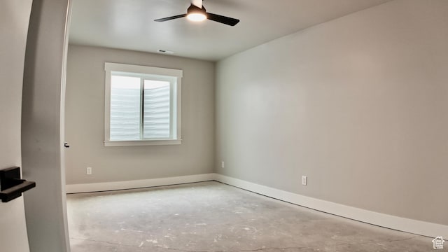 empty room featuring concrete flooring, baseboards, a ceiling fan, and visible vents