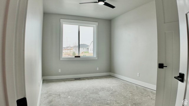 empty room with baseboards and a ceiling fan