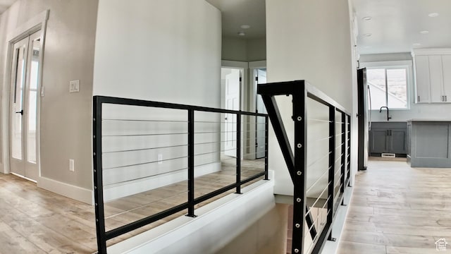 stairway featuring baseboards and wood finished floors
