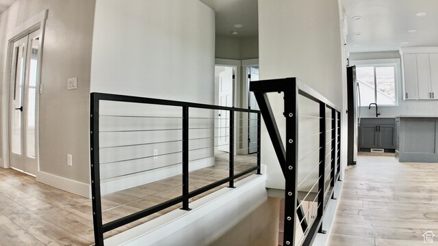 stairway featuring baseboards and wood finished floors