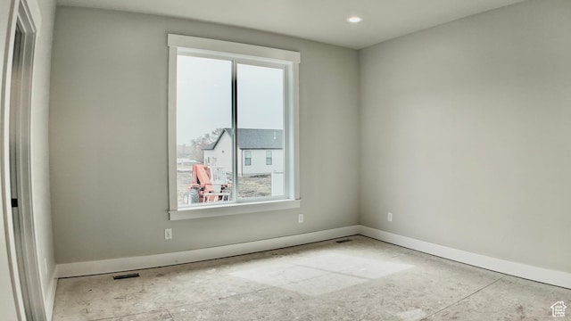 empty room featuring recessed lighting, visible vents, and baseboards