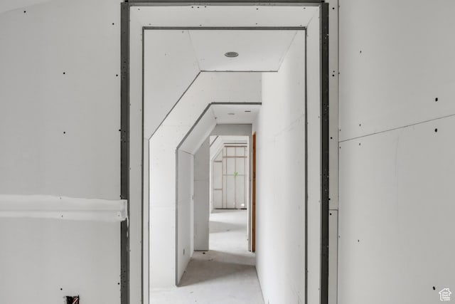 corridor with vaulted ceiling