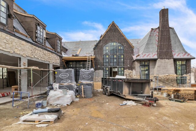 rear view of property featuring a chimney