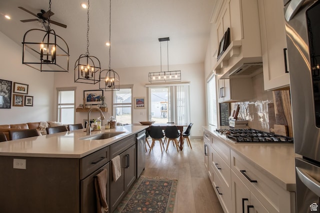1438 N Jerry Gertsch Ln, Midway, UT 84049 - kitchen featuring light countertops, a sink, appliances with stainless steel finishes, open floor plan, and light wood-style flooring