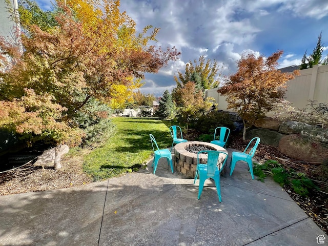 view of patio / terrace featuring an outdoor fire pit and fence private yard