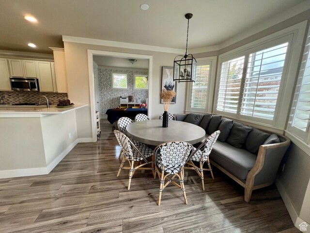 dining room featuring light wood finished floors, baseboards, recessed lighting, and an inviting chandelier