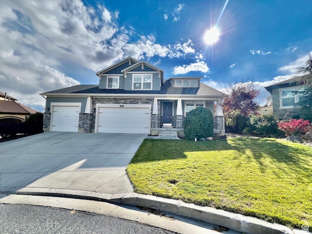 craftsman inspired home featuring driveway, stucco siding, stone siding, and a front yard