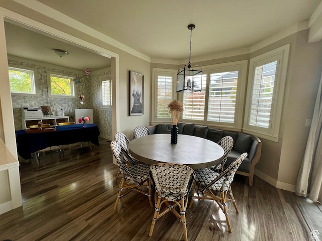 dining room with baseboards, wood finished floors, and a chandelier