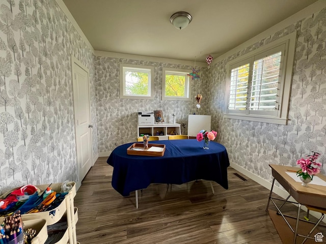 recreation room with baseboards, wallpapered walls, and wood finished floors