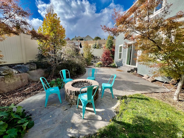 view of patio featuring an outdoor fire pit, a fenced backyard, and entry steps