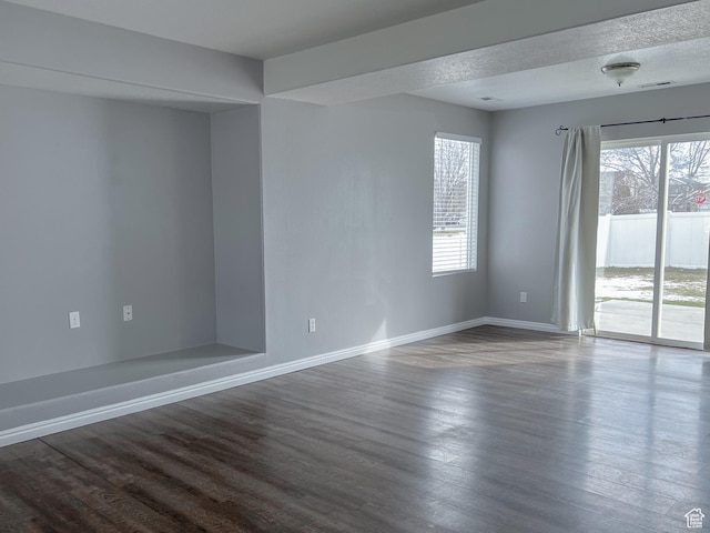 5498 Scarsborough Way, Stansbury Park, UT 84074 - unfurnished room featuring baseboards and dark wood finished floors