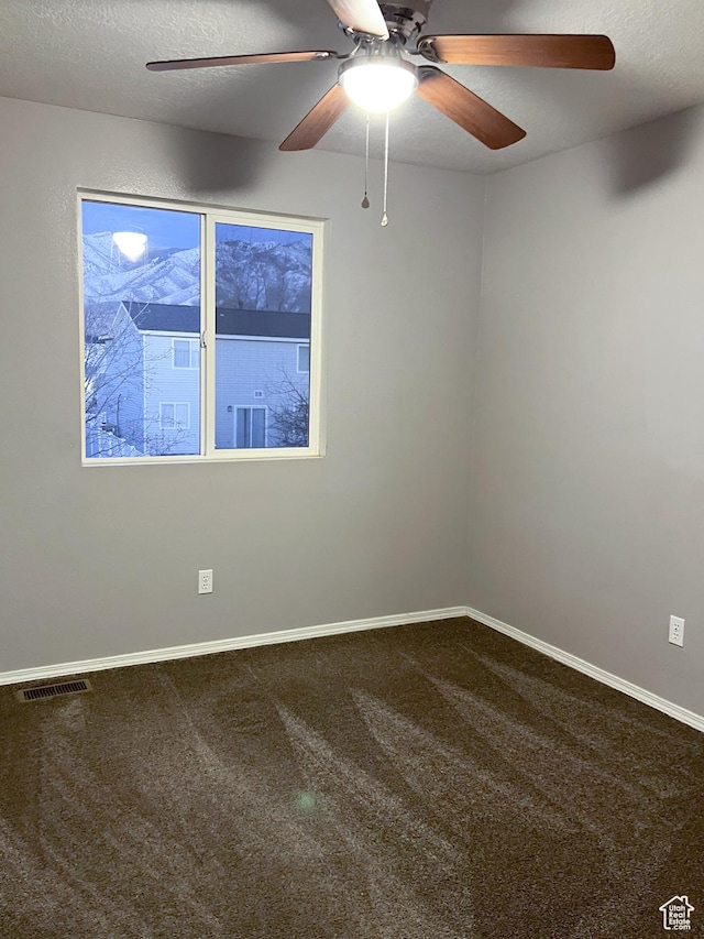 5498 Scarsborough Way, Stansbury Park, UT 84074 - spare room with carpet flooring, a ceiling fan, baseboards, and a textured ceiling