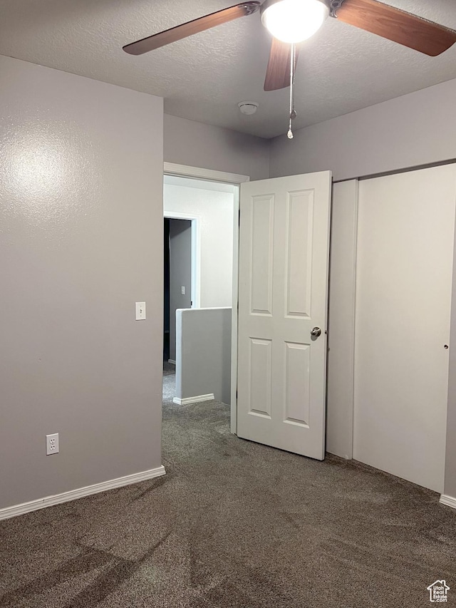 5498 Scarsborough Way, Stansbury Park, UT 84074 - unfurnished bedroom with carpet flooring, a closet, ceiling fan, and baseboards