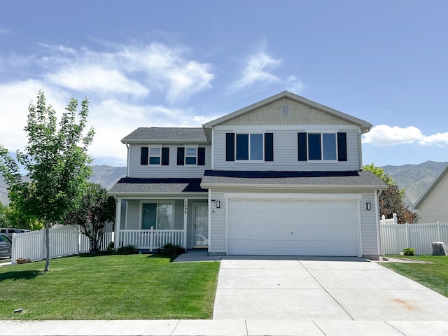 5498 Scarsborough Way, Stansbury Park, UT 84074 - traditional-style house featuring covered porch, driveway, a garage, and a mountain view