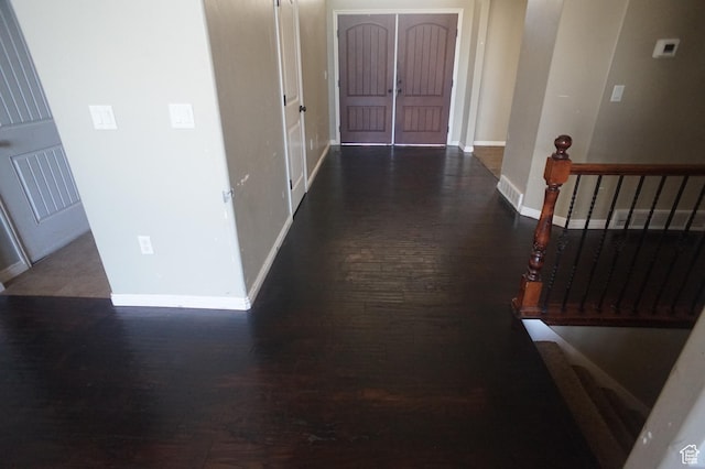 hall with baseboards, visible vents, wood finished floors, and arched walkways