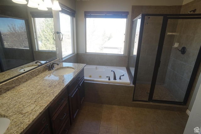 bathroom with tile patterned flooring, vanity, a whirlpool tub, and a stall shower