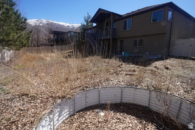 view of yard with stairway, fence, and a deck with mountain view