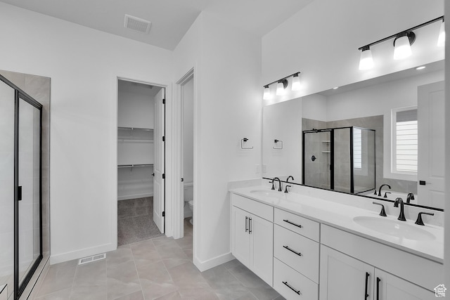 253 E Polaris Dr Unit 105, Saratoga Springs, UT 84045 - bathroom with a shower stall, double vanity, and a spacious closet