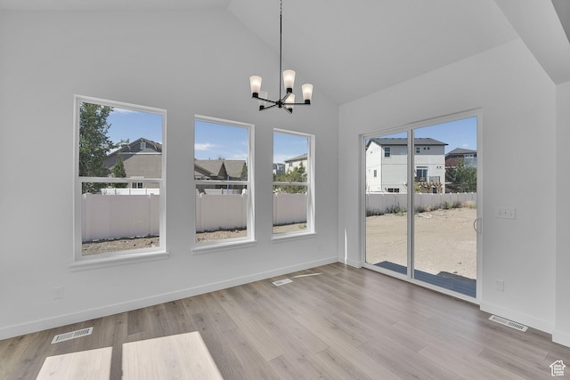 253 E Polaris Dr Unit 105, Saratoga Springs, UT 84045 - unfurnished dining area with a chandelier, healthy amount of natural light, high vaulted ceiling, and wood finished floors